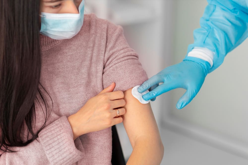Healthcare professional providing on-site flu vaccination to an employee.